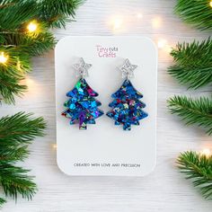 Christmas tree earrings, Xmas gift, glitter earrings, christmas jewelry--these charming Christmas tree earrings are the perfect Christmas gift for her, designed to add festive cheer to any outfit. Adorned with a sparkling gold or silver stud star topper, these earrings are crafted from chunky glitter acrylic in vibrant shades of pink, green, blue, or pastel.  Measuring approximately 1.5" tall and 1" wide, they offer the perfect balance of seasonal style and comfort. With hypoallergenic stainless steel findings, these earrings are not only stylish but also durable and comfortable for long-term wear. Arriving in a gift bag accompanied by a polishing cloth, these earrings are carefully packaged in a shipping box to guarantee their safe journey to you. Should you have any inquiries, please do Glitter Drop Earrings As A Gift, Blue Earrings For Christmas Gift, Resin Christmas Tree, Blue Christmas Tree, Christmas Party Gift, Tree Earrings, Christmas Tree Earrings, Glitter Earrings, Glitter Acrylics