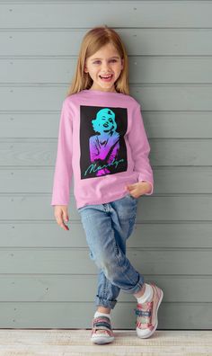 Wrap your little one in iconic style with the Marilyn Monroe Gradient Colors Toddler Pullover Tee. This adorable Long Sleeve Shirt features a vibrant gradient colors design that pays homage to the timeless beauty of Marilyn Monroe. Crafted with care, this Long Sleeve Tee is made with high-quality materials to ensure comfort and durability for your toddler. The pullover style makes it easy to dress your little one, while the hood adds an extra layer of warmth on chilly days. Designed by INHOLLYWOODLAND, a brand known for their attention to detail and unique designs, this Tee is a must-have for trendy toddlers everywhere. Let your little one shine bright and make a fashion statement with the Marilyn Monroe Gradient Colors Toddler Pullover Long Sleeve Tee. Designed to bring the best to the yo Pop Culture Cartoon Print Long Sleeve Tops, Long Sleeve Cartoon Print Pop Culture Tops, Pink Long Sleeve T-shirt With Character Print, Long Sleeve Tops With Cartoon Print, Pop Culture Graphic Long Sleeve Tops, Retro Long Sleeve Tops With Character Print, Retro Long Sleeve T-shirt With Character Print, Pink Pop Culture Tops With Funny Print, Pink Pop Culture Top With Funny Print