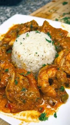 a white plate topped with shrimp and rice