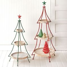 three christmas tree shaped trays sitting next to each other on top of a white floor