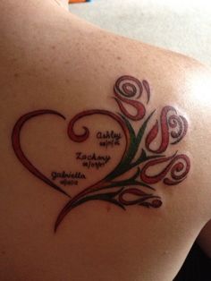 the back of a woman's shoulder with a tattoo on it