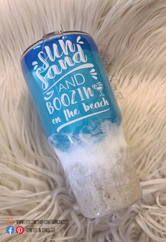 a can of slushy sand and boozing on the beach is laying on some white fur