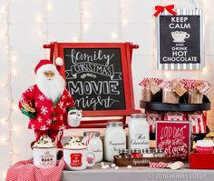 a christmas movie night party with santa clause and popcorn buckets, milk bottles, marshmallows