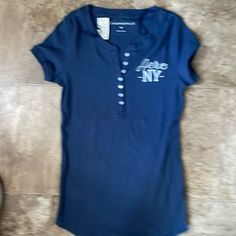 Brand New Blue T-shirt With Button Closure And Crew Neck, Casual Blue T-shirt With Buttons, Blue Casual Tops With Button Closure, Blue Crew Neck Shirt With Button Closure, Navy Casual Tops With Button Closure, Casual Navy Tops With Button Closure, Fire Shoes, Aeropostale Shirt, Movie Ideas