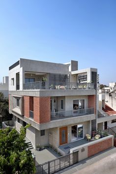 an apartment building with balconies on the second floor