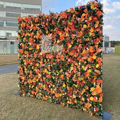 an artificial flower wall in front of a building