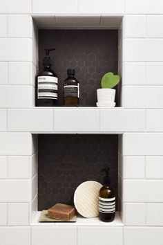 two shelves with soaps, lotion and other items on them