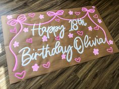 a birthday sign on the floor with hearts