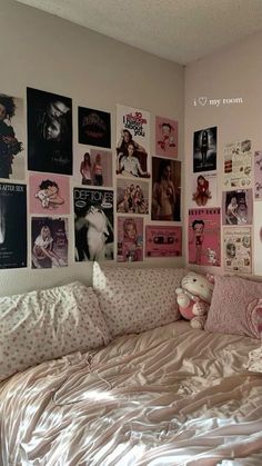 a bedroom with posters on the wall and a bed in it's center area