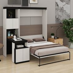 a bedroom with a bed, desk and chair next to a wall mounted bookcase