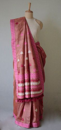 A genuine handloom product from the looms of Assam, India. The Sari has  mulberry silk in the warp and Tassar silk in the weft and the interweaving motifs in Cotton and acrylic Tassar Silk is a variety of wild silk found in the central Indian states of Chattisgarh , Jharkhand and Orissa. The yarns naturally occurs in soft beige to light brown colours. In this case , we have used dyed tassar silk yarns in the weft.  The tassar yarns gives the saree a crisp fall .  The sari is very soft , light  a Festival Slub Silk Pre-draped Saree With Weaving Work, Diwali Slub Silk Pre-draped Saree With Weaving Work, Festival Pre-draped Chanderi Saree With Woven Motifs, Bohemian Handloom Pre-draped Saree, Transitional Bollywood Blouse Piece With Woven Motifs, Bohemian Pre-draped Pink Saree With Pallu, Bohemian Pre-draped Pink Saree, Tussar Silk Handloom Pre-draped Saree For Puja, Diwali Raw Silk Pre-draped Saree With Weaving Work