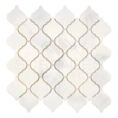 a white and gold tile with an intricate design