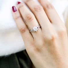 a woman's hand with a diamond ring on it