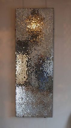 a mirror hanging on the side of a wall