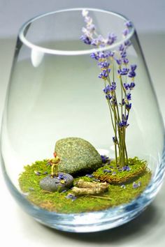 a glass vase filled with rocks and flowers