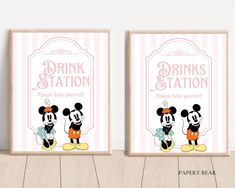 two framed posters with mickey and minnie mouses on the front, one is drinking station