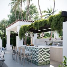 an outdoor kitchen and dining area with palm trees in the backgrouns,