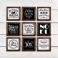 six framed christmas signs hanging on a white wooden wall with black and white typograms