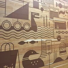 a wooden wall with many different designs on it