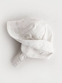 Perfect for year-round wear, this upf 50+ hat is functional and so handsome! Made in sand-colored twill, it has a flap to cover the neck and ears to protect from the wind. Three little buttons accent the crown. Made in an easy-care cotton and fully lined for comfort. • 100% Cotton • Cold handwash, Lay flat to dry • Made in China White Cotton Hat With Upf 50+, White Six-panel Cotton Hat, Playful White Cotton Hat, White One-size Outdoor Hat, White Adjustable Moisture-wicking Baseball Cap, White Hat, Upf 50, The Crown, The Wind