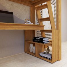 a desk with books and a computer on it next to a wall mounted shelf filled with books