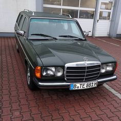 a mercedes benz parked in front of a building