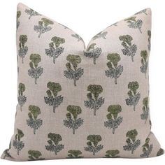 a white pillow with green broccoli on it