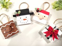 four small gift bags decorated with paper snowman, santa clause, and reindeer head