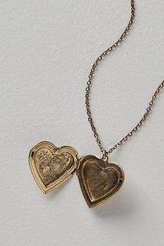 A super sweet gift or an accessory unique to you, this darling monogram necklace features a heart locket pendant with an initial engraving. **Features:** Dainty chain, heart locket pendant, hinge opening mechanism, monogram initial engraving, clasp closure **Why We | Monogram Necklace by Free People in Gold Open Locket, Tv Journal, Meaningful Pictures, Picture Locket, Chain Heart, Sweet Necklace, Dainty Chain, Monogram Necklace, Sweet Gifts