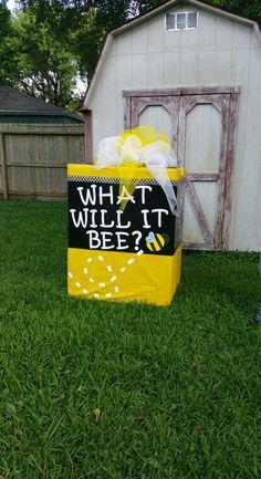 a yellow bag with what will it bee? written on it sitting in the grass