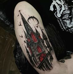 a man with a tattoo on his arm that has a castle and bats in it