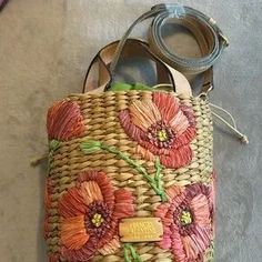 a woven purse with flowers on it