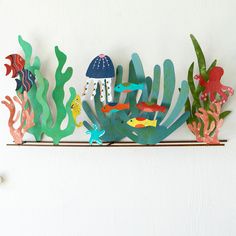 paper cut out of sea animals and fish on a shelf with corals, plants and other marine life