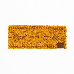 a yellow knitted headband is shown against a white background and has a brown leather tag on it