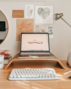 a laptop computer sitting on top of a wooden desk next to a keyboard and mouse