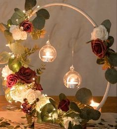 an arrangement of flowers and lights on a table