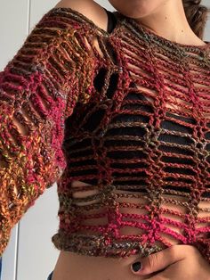 a close up of a woman's shirt with crocheted patterns on it