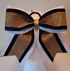 This hairbow is made with 3 inch white grosgrain ribbon layered with solid navy blue topped with gold glitter. This bow measures approximately 6 inches left to right and approximately 5 1/2 inches from the bottom of the center knot to the end of the tail. If you like this style but need another color combination or need more bows than in stock quantity please let message me to have something made special for you. I do work with teams and groups. Special pricing for orders of 12 or more. Navy And Gold Hair Bow, Navy Blue And Gold, Navy Blue Top, Blue And Gold, Color Combination, Grosgrain Ribbon, Gold Glitter, Hair Ties, Color Combinations