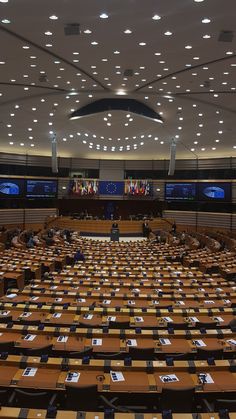 an empty conference room with rows of tables