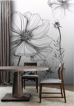 a dining room with flowers painted on the wall and two chairs in front of it