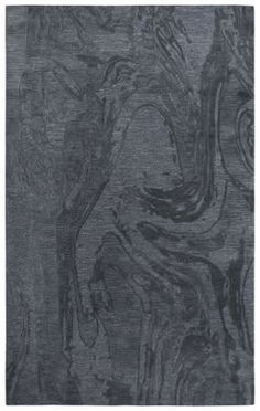 an area rug with grey and black designs on it