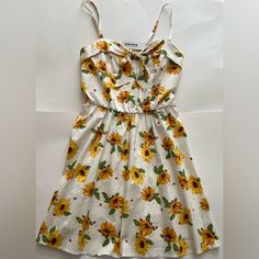 White And Yellow Sundress With Sunflowers And Ladybugs. Has Adjustable Straps And Adjustable Bow And The Front. I Am 5’4 And The Dress Falls Just Above My Knees. Has Never Been Worn Before And Still Has The Tag Attached. Yellow Floral Dress For Spring And Summer, Floral Print Sundress For Daytime, Daytime Floral Print Sundress, Spring Casual Sundress With Daisy Print, Casual Daisy Print Floral Dress For Summer, Yellow Flowy Floral Dress For Vacation, Casual Spaghetti Strap Floral Dress For Brunch, Casual Floral Dress With Spaghetti Straps For Brunch, Flowy Yellow Floral Dress For Vacation