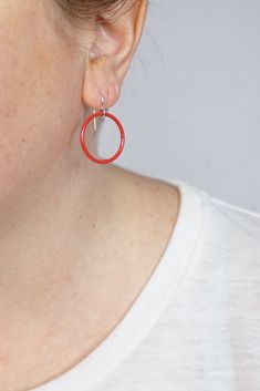 These lightweight circle earrings are sure to become your new favorite pair. An update on classic hoops, each circle retains evidence of their making - a small dot marks the spot where I hand-weld each earring. Approximately 1 1/4" tall (including ear wires) and 7/8" wide. Powder coated in a bright red color. Sterling silver ear wires. Handcrafted in my Pennsylvania studio. Ships in 1-2 business days. Comes in a gift box. Treat yourself or a loved one! Hypoallergenic Red Round Jewelry, Small Hoop Red Earrings For Everyday, Red Sterling Silver Hoop Earrings, Red Sterling Silver Round Hoop Earrings, Minimalist Red Round Earrings, Red Jewelry With Matching Earrings For Everyday, Modern Red Round Earrings, Red Everyday Earrings, Adjustable Red Hoop Earrings