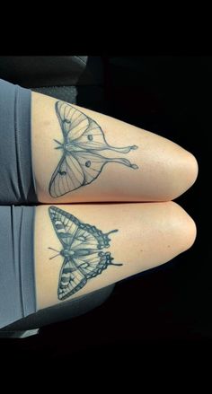 two women with tattoos on their legs, one has a butterfly and the other has a bird