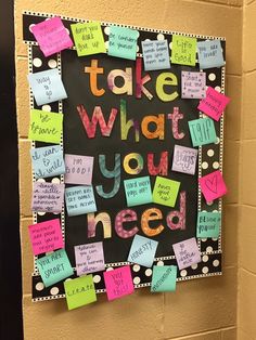 a bulletin board with post it notes attached to the back of it that says take what you need