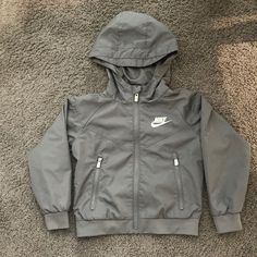 Adorable Gray Nike Jacket With Two Zippered Pockets. Worn Once. Size 3t Nike Gray Hooded Jacket, Nike Gray Windbreaker For Winter, Nike Gray Long Sleeve Hooded Jacket, Nike Gray Windbreaker For Fall, Nike Gray Hooded Jacket For Fall, Casual Long Sleeve Outerwear For Play, Hooded Outerwear For Spring Playwear, Hooded Winter Outerwear For Playwear, Long Sleeve Outerwear With Pockets For Play