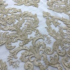 an intricately detailed white and gold fabric