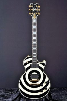 a black and white guitar sitting on top of a table