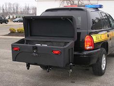 the back end of a black truck with a yellow and blue stripe on it's tailgate