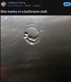 a smiley face drawn on the side of a metal tank with water droplets in it